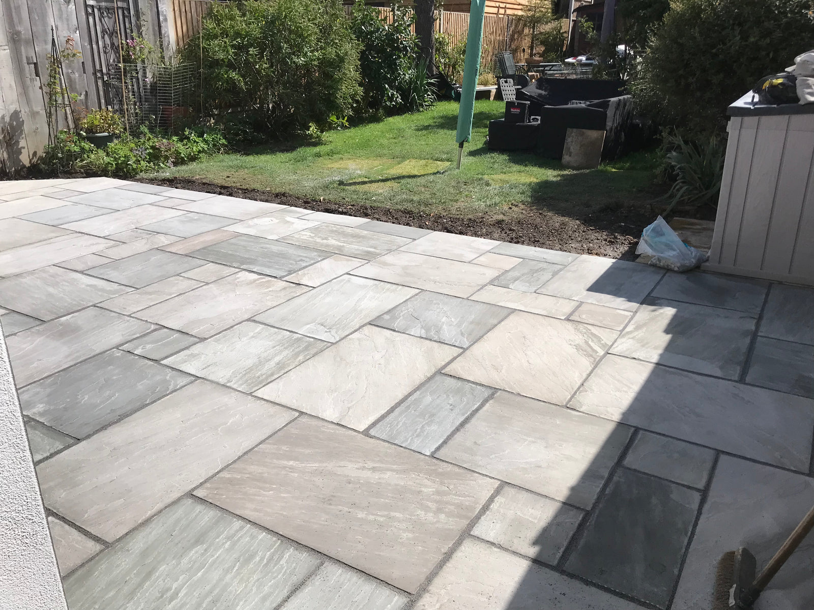 Kandla Grey sandstone paving slabs installed on modern garden patio