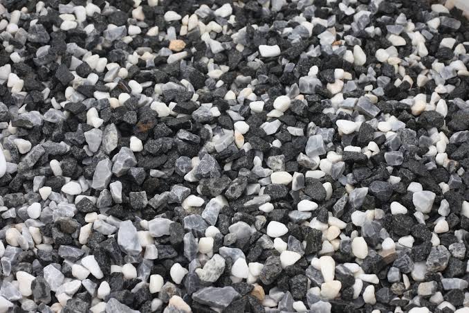 Close-up of 20mm Black Ice chippings showing dark grey and black angular stone gravel
